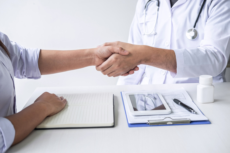 Doctor Shaking Hands with Client